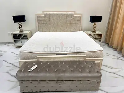 King size bed (without mattress) along with Ottoman, 2 side tables and 2 table lamps.