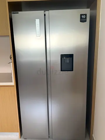 Large stainless steel side-by-side refrigerator with water dispenser - good condition