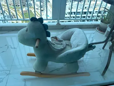 Plush rocking MUSIC dinosaur with wooden rockers - gently used