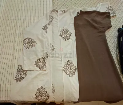 Two casual women's tops — cream printed open-front and brown short-sleeve dress/top