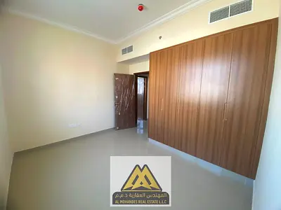 Two-bedroom apartment for annual rent in Al Jurf 3, Ajman. First tenant, luxury finishes, balcony, 3 bathrooms, central AC, spacious area, near Sheikh