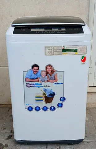 topload Aftron 7kg fully automatic washing machine, color is white, condition is properly working.