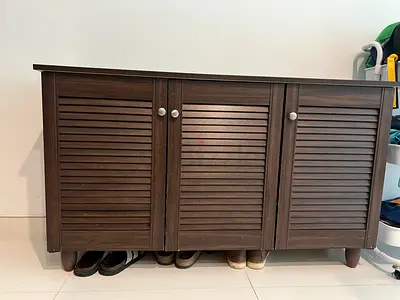 Dark wood 3-door shoe cabinet with louvered doors