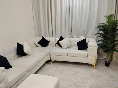 L-shaped tufted cream fabric sofa set with gold legs - good condition