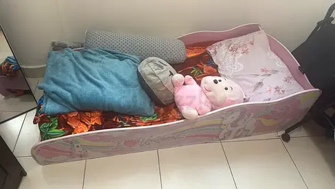 Pink unicorn toddler bed with side rails and mattress