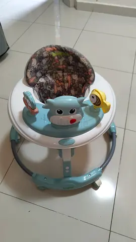 Light blue baby walker with padded seat and toys - good condition