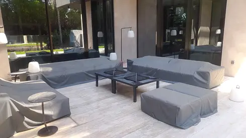 Outdoor patio sofa set with covered cushions and coffee tables
