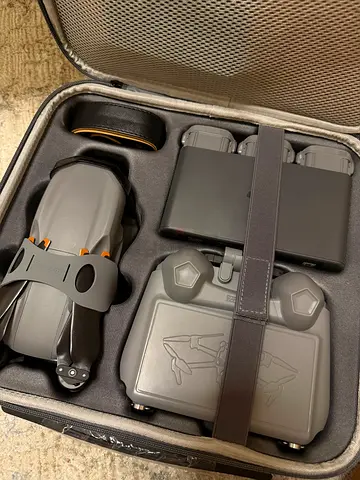 Compact foldable drone with controller and charging hub in protective case