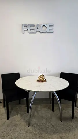 Small round dining table with The one  two black chairs - marble top wrap glass top