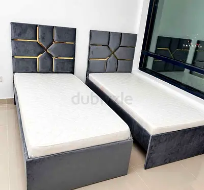 Pair of grey velvet single beds with mattresses, new