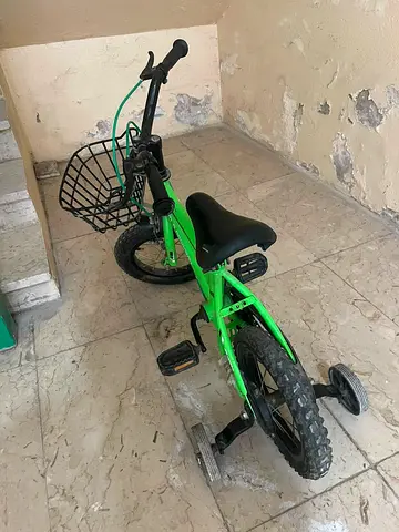 Kids' bright green 12-inch bike with training wheels and front basket