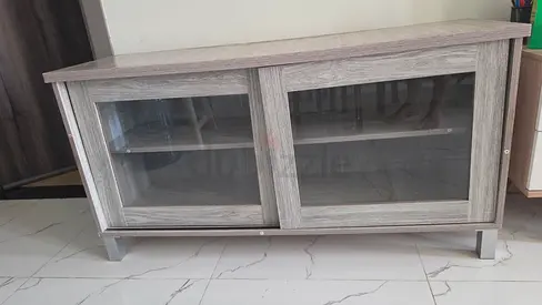 Grey wooden TV unit / media console with sliding glass doors