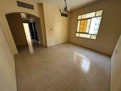 Next to Ajman Towers 1 in Al Rashidiya 3 near the Corniche! Two-bedroom apartment with a large living room, 2 bathrooms, central air conditioning, and