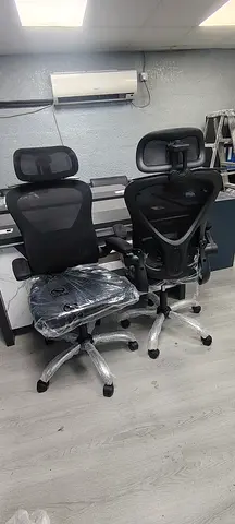 Pair of ergonomic black mesh office chairs with headrests - good condition