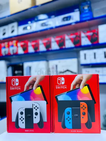 Pair of Nintendo Switch OLED consoles – White and Neon (brand new boxes)