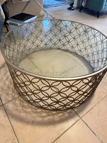 Round glass top coffee table with metallic lattice frame