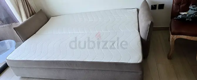 Light grey upholstered sofa bed with mattress - good condition