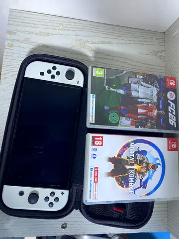 Nintendo Switch OLED (White) with carrying case + 2 games (Mortal Kombat & FC 26)