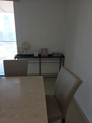 Modern glass-top dining table with four chairs and console shelf