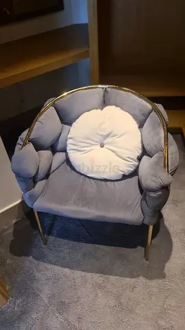 Grey velvet accent armchair with gold frame and cushion