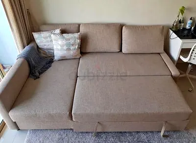 Beige L-Shaped Sofa Bed with Pull-Out Section