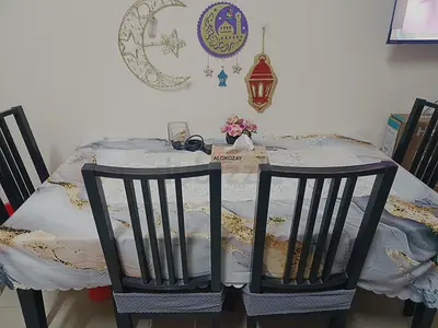 Dining table with 4 chairs and decorative tablecloth - good condition