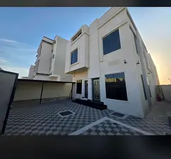 Villa in Al Bahia with a spacious yard and covered parking. It includes 3 bedrooms, a living room, a