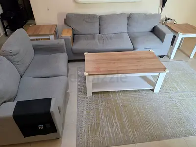 Light grey 3-seater sofa with 2 seater sofa, coffee table and side tables and tv unit. Set.