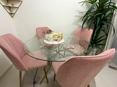 Round Glass Dining Table with 4 Pink Upholstered Chairs