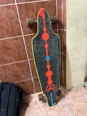 Used Longboard Skateboard with Red and Yellow Graphic