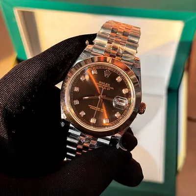 This is a Rolex Datejust 41 (Ref. 126301) featuring a chocolate brown dial with diamond markers.