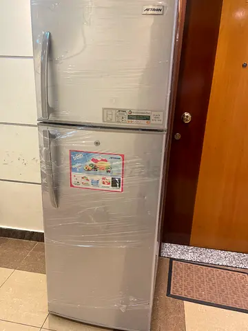 Silver double-door refrigerator with top freezer - good condition