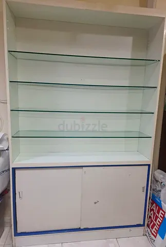 White display cabinet with glass shelves and storage cupboard