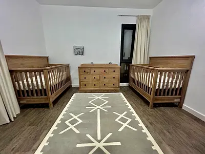 Pair of wooden baby cribs from Crate & Barrel