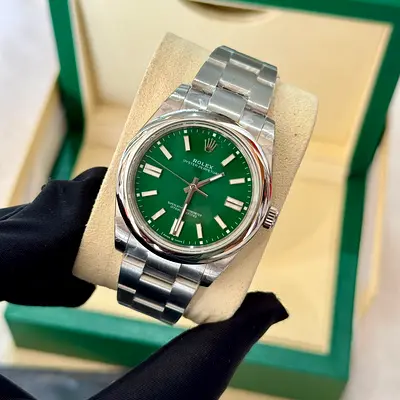 This is a Rolex Oyster Perpetual 35mm watch featuring a distinctive green dial and stainless steel O