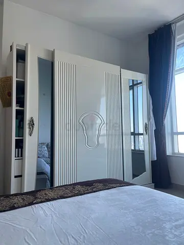 White decorative wardrobe with mirrored doors and ornate detailing. available only till tomorrow