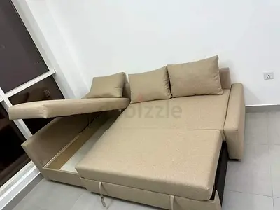 Beige L-shaped sofa bed with storage — good condition