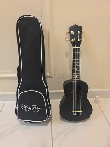 Small black soprano ukulele with padded gig bag - good condition