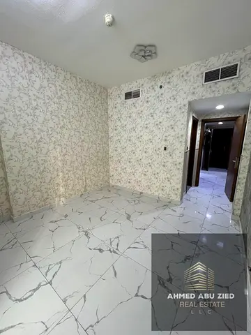 Luxurious three-bedroom apartment for annual rent in Al Waha Towers, Ajman. Features include three master bedrooms, full sea views, a gym, swimming po