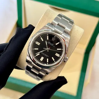 This is a Rolex Oyster Perpetual 41mm with a black dial and steel bracelet, model 124300.Model: Role