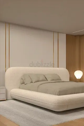 Modern upholstered king bed with curved headboard and platform base