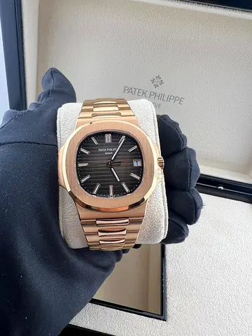 This appears to be a Patek Philippe Nautilus 5711/1R-001 in 18k rose gold with a brown sunburst dial