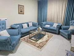 Furnished one-bedroom apartment with a living room for monthly rent in Al Taawun, Sharjah.