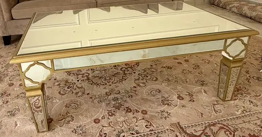 Glass-top mirrored coffee table with gold frame
