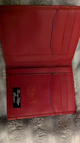 Red leather bi-fold wallet with card slots