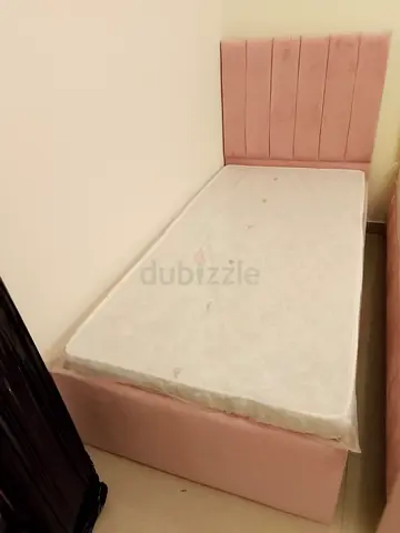 Single Pink Upholstered Bed with Headboard -