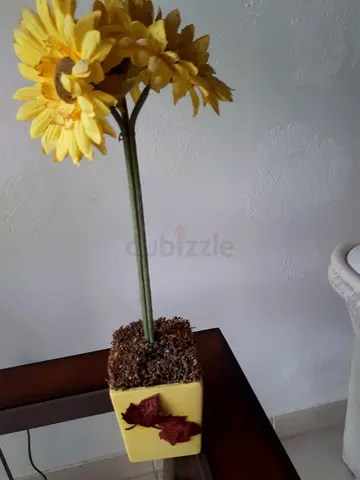 Artificial sunflower arrangement in yellow decorative pot