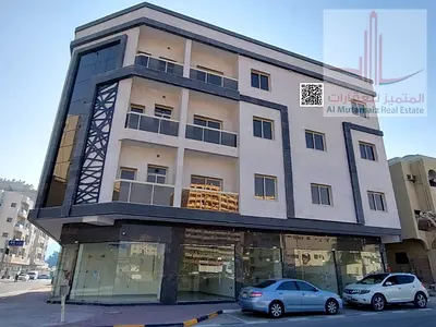 Two bedrooms and a living room in Al Rashidiya, new building, location close to all services.