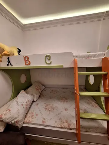 Kids bunk bed with ladder and floral mattress