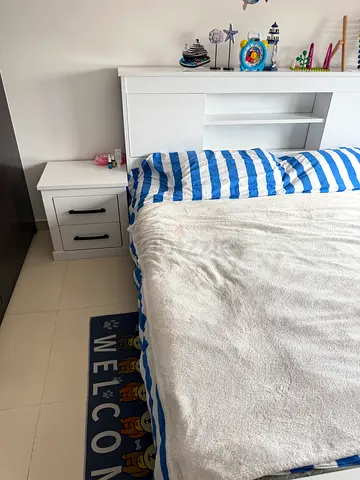 White single bed frame with headboard and matching bedside drawer